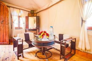 a dining room with a table with fruit on it at Riad Lamane in Zagora