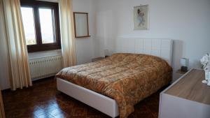 a bedroom with a bed and a window at Appartamento Nerio in Muggia
