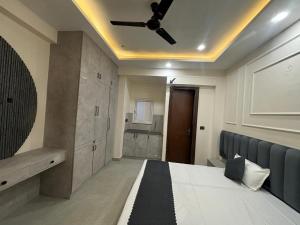 a bedroom with a bed and a ceiling fan at Pg walaah suites in Noida