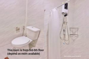a bathroom with a toilet and a shower at Thai Orchid Guest House in Jomtien Beach +31 photos