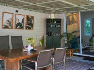 a dining room with a wooden table and chairs at Three Palms - Beach Front Tiny House by SP Villa in Nathon Bay +23 photos