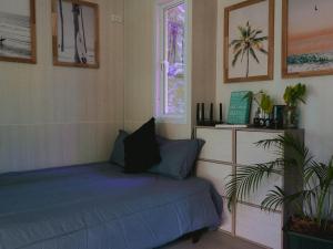 a bedroom with a bed and a window at Three Palms - Beach Front Tiny House by SP Villa in Nathon Bay