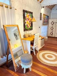 a room with a table with a mirror and a chair at Biba Beach Village in Gili Islands