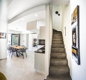 a staircase leading to the kitchen and dining room in a house at Villa Daniela & Apartments in Koutsounari