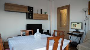 a dining room with a table with a vase on it at Appartamento Nerio in Muggia
