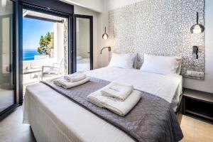 a bedroom with a bed with towels on it at Villa Daniela & Apartments in Koutsounari +86 photos