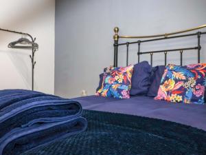 a bed with purple sheets and pillows on it at Chalet 3 in Ganton