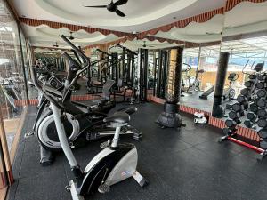 a gym with several treadmills and a treadmill at Sunshine Patong in Patong Beach