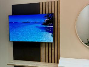 a flat screen tv hanging on a wall at Deluxe Nest - Windhoek in Windhoek