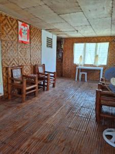 a room with wooden chairs and a table in it at Dapearl Cottage in Baclayon +20 photos