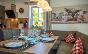 a dining room table with plates and glasses on it at Ferienhaus Benedikt in Fichtelberg