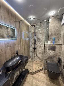 a bathroom with a sink and a glass shower at Gyumri Moderna in Gyumri +27 photos