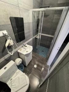 a bathroom with a toilet and a sink and a shower at White Guest in Fátima +23 photos