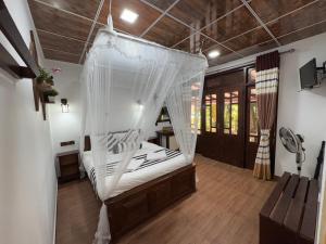 a bedroom with a bed with a mosquito net at Home Away Ella in Ella