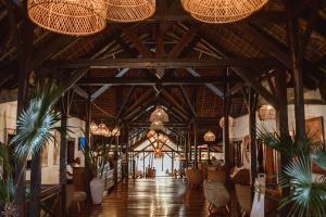a large room with wooden ceilings and chandeliers at Vanila Hotel & Spa in Ambaro +111 photos