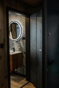 a bathroom with a mirror and a sink at Domek Jak z Obrazka in Sierpnica +44 photos