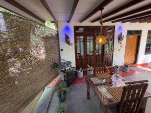 a patio with a table and chairs and a wall at Home Away Ella in Ella