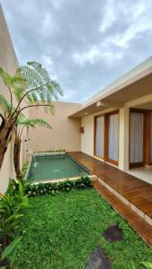 a small swimming pool in the backyard of a house at Kamaya Villa Jogja in Ngaglik