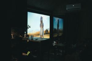 a television screen with a woman standing on it at Domek Jak z Obrazka in Sierpnica