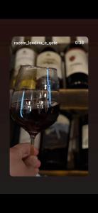 a person holding a glass of wine in their hand at Razem Lendina e Qete in Razëm +71 photos