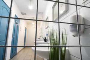 a bathroom with a row of sinks and toilets at WOW City Hostel in Budapest +35 photos