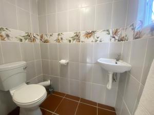 a bathroom with a toilet and a sink at Fishermans Cottage - BillsBest in Port Edward +12 photos