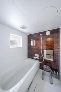 a bathroom with a bath tub and a sink at Hills Niseko A in Niseko