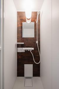 a bathroom with a toilet with a light on the wall at Hills Niseko A in Niseko
