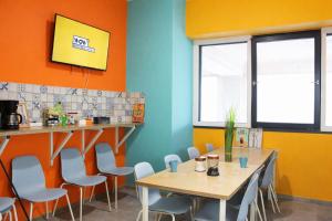a restaurant with tables and chairs in a room at WOW City Hostel in Budapest