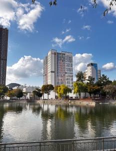 a city with tall buildings and a body of water at 썸원호텔 in Yŏsu