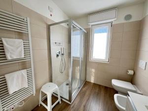 a bathroom with a shower and a toilet at BedE-Bike Apartments in Casazza +105 photos