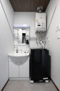 a bathroom with a sink and a mirror at Hills Niseko A in Niseko +83 photos