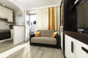 a living room with a couch and a television at Apartment Jelusic in Baška +12 photos