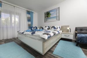 a bedroom with a bed and a window at Apartment Jelusic in Baška