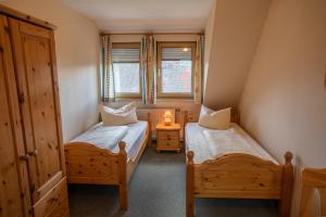 a bedroom with two beds and a window at Gutshof Colmberg in Colmberg