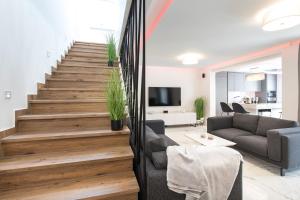 a living room with a staircase and a couch at Villa Aurora in Baška