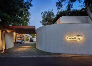 a building with a sign on the side of a wall at Lyvin Bingin Villas in Uluwatu
