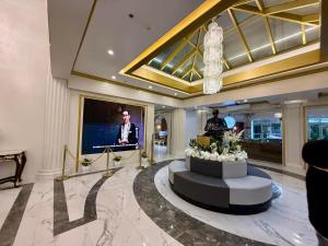 a lobby with a television and a table with flowers at Wright Park Hotel in Baguio