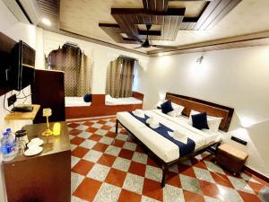 a bedroom with a large bed and a checkered floor at The Lake Haveli in Udaipur