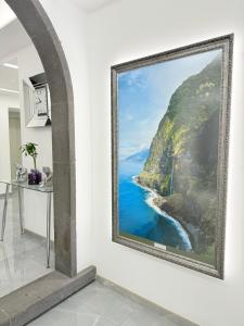 a painting of a coast on a wall at Gold Center Funchal 101 in Funchal
