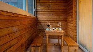 a sauna with a table and two glasses of wine at Gapyeong Areuno Pet Pension in Gapyeong