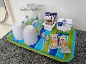 a tray with cups and utensils on a table at Boathouse Bed and Biscuit - Cabin in Margate