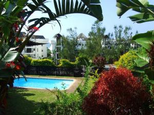 a swimming pool in a yard with buildings in the background at Boathouse Bed and Biscuit - Cabin in Margate