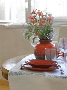 a table with a vase with flowers on it at Downtown dell Arte in Novi Sad