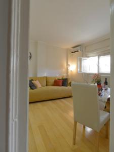 a living room with a couch and a table at Downtown dell Arte in Novi Sad