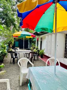 a table with a colorful umbrella on a patio at Villa Beach Heaven in Hikkaduwa +19 photos