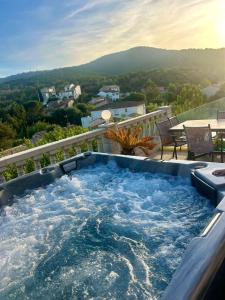 a hot tub on the balcony of a house at Chambre avec piscine, jacuzzi, vue mer et montagne, plage à pied in Roquebrune-sur-Argens