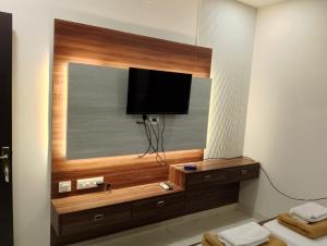 a flat screen tv on a wall in a room at VR Homes in Chennai