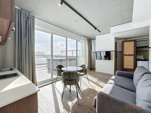 a living room with a couch and a table at South 32 Hotel by Zzzing in Birżebbuġa