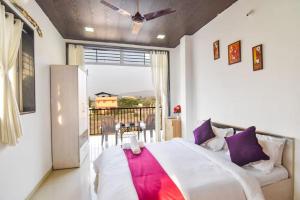 a bedroom with a large bed and a balcony at ll EMPYREAN STAY ll LUXE ll FORTUNE VILLA ll 4BHK ll AC ll BIG POOL in Lonavala